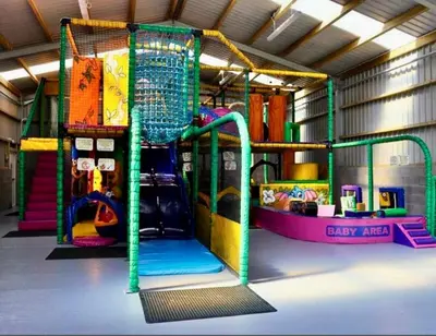 a play room with a playground with a slide at Loch View 28 in Stranraer