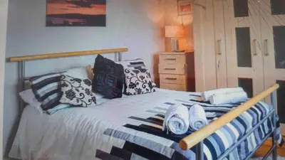 a bedroom with a bed with blue and white pillows at Ocean View in Port William