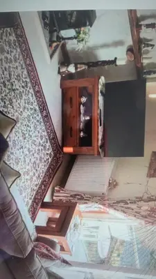 a room with a bed and a wooden dresser at Riverside Cottage in Minnigaff