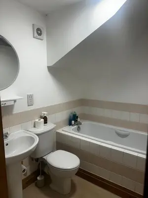 a bathroom with a toilet and a sink and a tub at The Dairy in Moffat