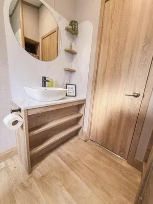 a bathroom with a sink and a mirror at Hornbeam Lodge in Bassenthwaite