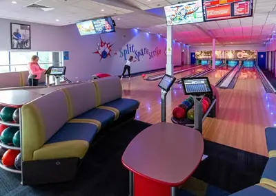 a bowling alley with a woman playing bowling at Stanwix Park in Silloth