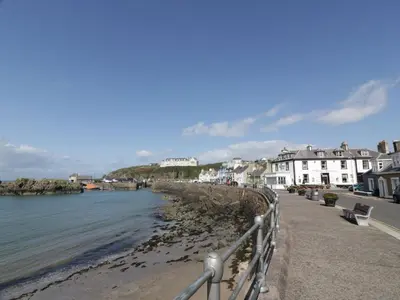 a view of a beach with houses and the water at Peaceful in Stranraer