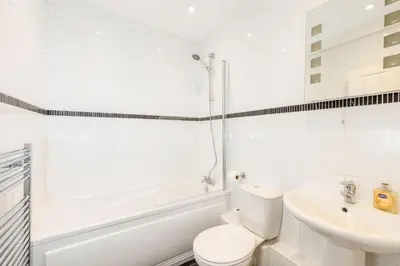a white bathroom with a toilet and a sink at North Loft a Modern Apartment in Cockermouth in Cockermouth