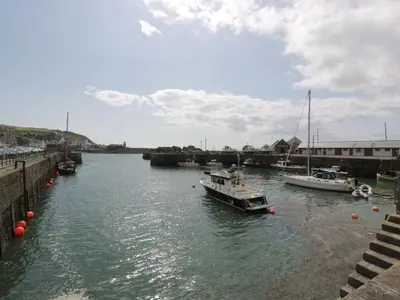 a group of boats are docked in a river at Ellies House in Stranraer