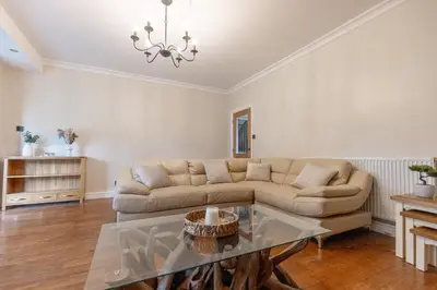 a living room with a couch and a table at EASTCOTE FARM - Spacious 5-Bed Home with Views, Garden & Playroom in Silloth