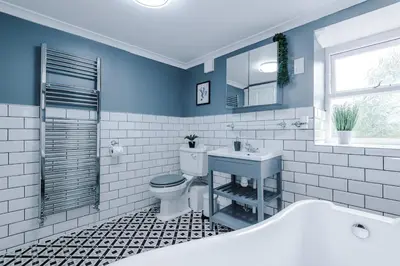 a bathroom with a toilet and a sink and a tub at Springholm Cottage Family Retreat - Sleeps 10 in Bootle