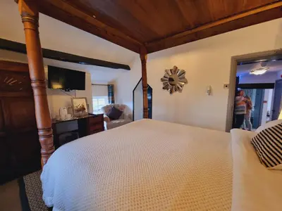a bedroom with a large bed and a television at Lane Head Farm Country Guest House in Troutbeck