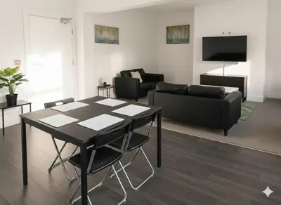 a living room with a table and a couch at Esk View House in Carlisle