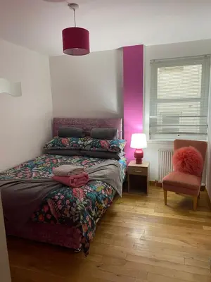 a bedroom with a bed and a chair at Number one faraline in Moffat