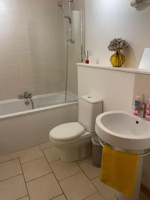 a white bathroom with a toilet and a sink at Number one faraline in Moffat