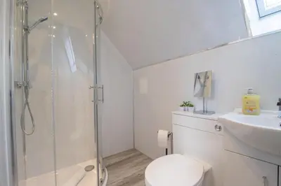 a bathroom with a shower and a toilet and a sink at Corsehill Cottage - 3 Bedroom, 2 bathroom House in Dreghorn