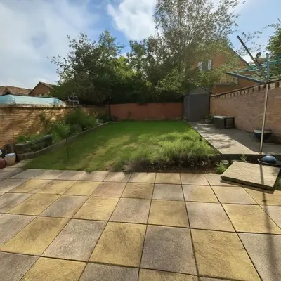 a garden with a patio and a lawn at Clapham Road Apartment in Moffat
