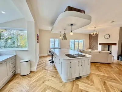 a kitchen with a large white island in a room at Jaytrees, Keswick - Luxury bungalow with hot tub in Keswick
