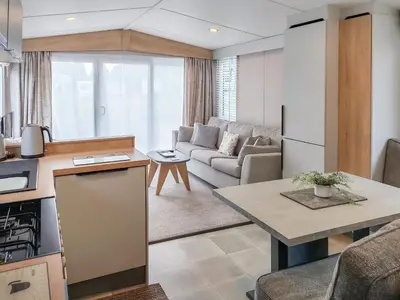 a kitchen and living room with a couch and a table at Melfell View - Uk50086 in Penruddock