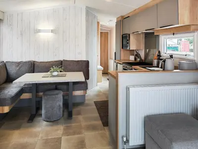 a kitchen and living room with a table and a couch at Melfell View - Uk50086 in Penruddock