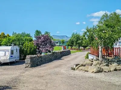a rv parked next to a stone wall at Melfell View - Uk50086 in Penruddock