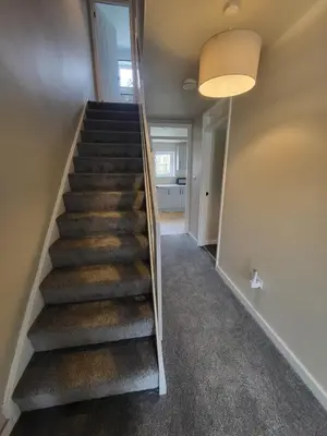 a stairway in a home with a hallway at The MacIntyre - Coorie Doon Stays in Kilmarnock
