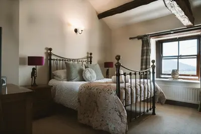 a bedroom with a bed and a window at The Farmhouse at Highside Farm in Bassenthwaite