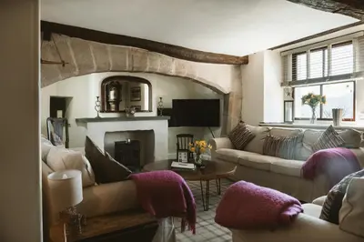 a living room with couches and a fireplace at The Farmhouse at Highside Farm in Bassenthwaite