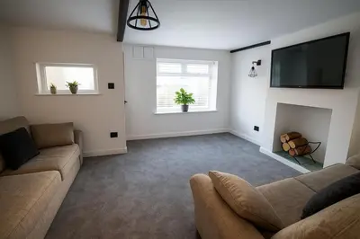 a living room with a couch and a fireplace at Cottage in Seaton in Siddick