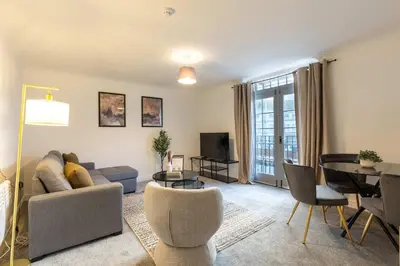 a living room with a couch and a table at Lovely 2BED Whitehaven Apartment with Sea Views in Whitehaven