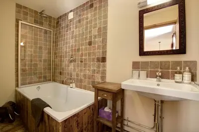 a bathroom with a tub and a sink and a bath tub at Lowthwaite B&B in Watermillock