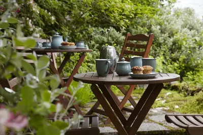 a picnic table with cups and muffins on it at Lowthwaite B&B in Watermillock