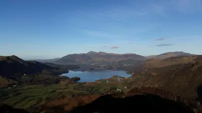 a view of a lake in the middle of a mountain at Hot tub, Mountain View, 4-poster bed and log burner in Borrowdale Valley