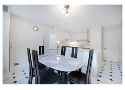 a dining room with a table and chairs in a kitchen at 14 Maple Mews in Moffat