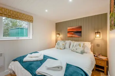 a bedroom with a large white bed with towels on it at 2 Bed in Mouswald oc-b33444 in Mouswald