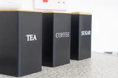 a row of black containers sitting on a counter at Your Perfect Home Away From Home in Workington