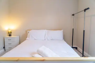 a bedroom with a bed with white sheets and pillows at Your Perfect Home Away From Home in Workington