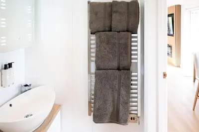 a bathroom with a towel rack next to a sink at Ardwall in Carsluith