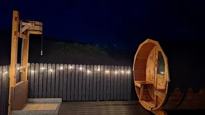 a wooden deck with a fence and a wooden door at Ardwall in Carsluith
