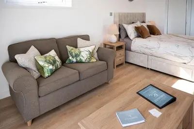 a living room with a couch and a bed at Barlocco in Carsluith