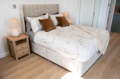 a bedroom with a bed and a night stand with a lamp at Barlocco in Carsluith