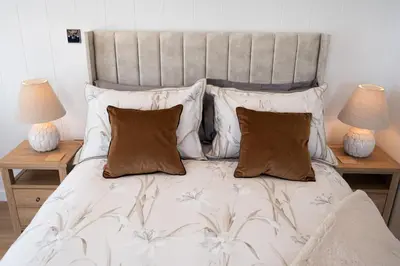 a bed with two lamps and two pillows on it at Barlocco in Carsluith