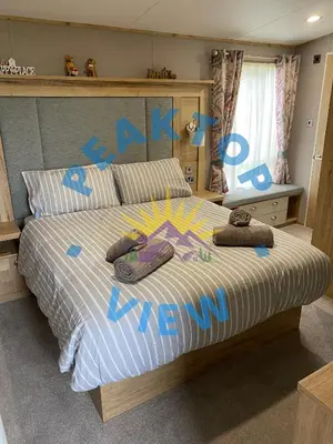 a bedroom with a bed with two slippers on it at Peaktop View, Winscales, near Cockermouth Cumbria in Winscales