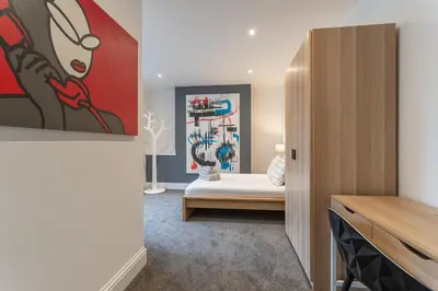 a living room with a painting on the wall at Faulkner Luxury Suites in Moffat