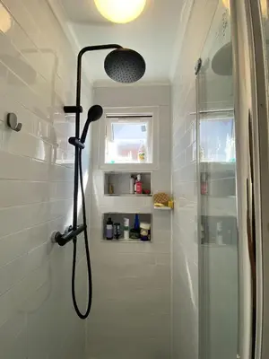 a shower with a shower head in a bathroom at Luxury Spacious Double Room, Mill Hill, London NW7 3BD in Moffat
