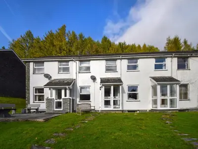 a large white house with a lawn in front of it at Quarry's Edge in Chapel Stile