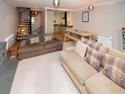 a living room with two couches and a table at Quarry's Edge in Chapel Stile