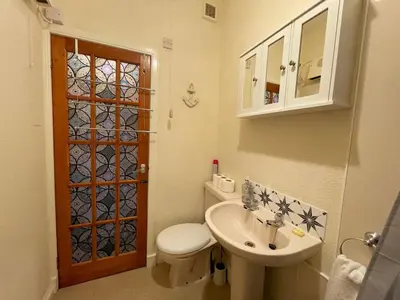 a small bathroom with a toilet and a sink at Pass the Keys Cosy Romantic Getaway with Hot Tub in Whithorn