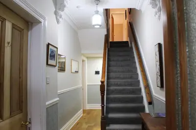 a hallway with stairs in a house at Sunnycroft - Hot tub hire available, fitness centre, free parking in Keswick