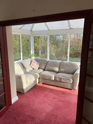 a living room with a couch in front of a window at The Holm in Canonbie