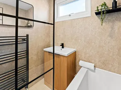 a bathroom with a sink and a bath tub at Edison House - Comfy Stay in Stafford in Moffat