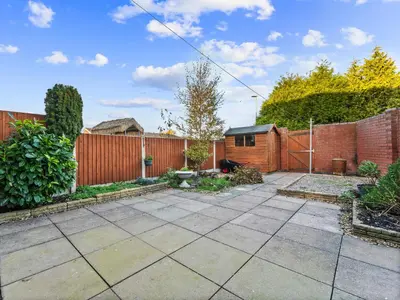 a garden with a brick fence and a patio at Edison House - Comfy Stay in Stafford in Moffat