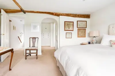 a bedroom with a bed and a desk and a chair at Woodlea Cottage in Moffat