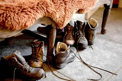 a group of boots sitting under a table at Victorian House in Grasmere
